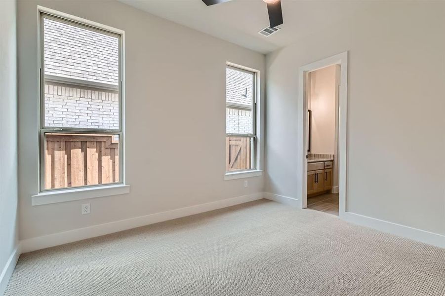 Unfurnished bedroom with carpet and ensuite bath Unfurnished bedroom with carpet and ensuite bath