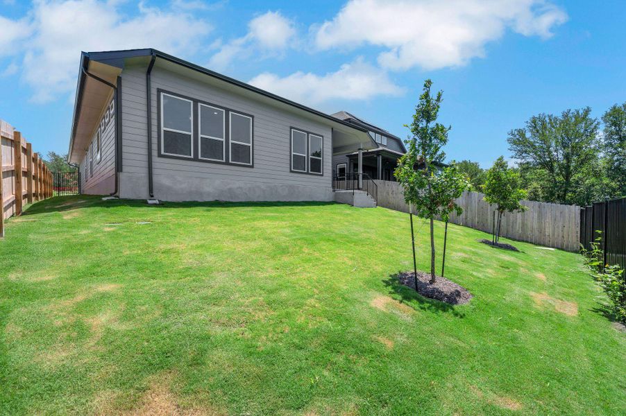 Rear view of house featuring a fenced backyard Rear view of house featuring a fenced backyard