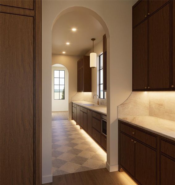 Framed by graceful arches, this auxiliary kitchen space is as refined as it is functional. With dedicated storage, ample prep area, and a sense of separation from the main living areas, it invites effortless entertaining behind the scenes.