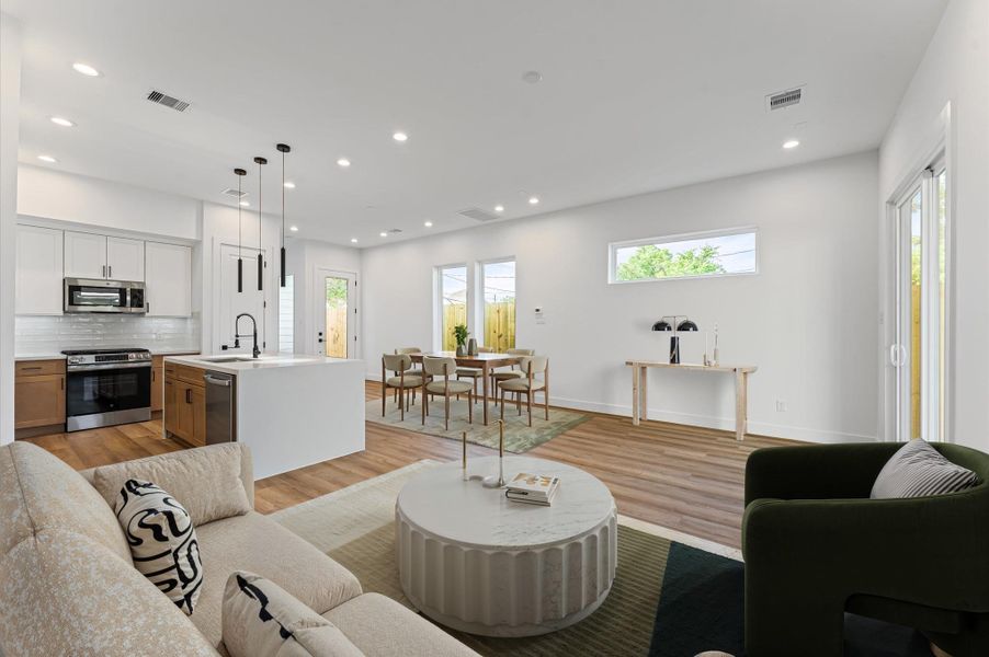 Photo has been virtually staged, a view from the living room into the open concept kitchen and dining area. Photo has been virtually staged, a view from the living room into the open concept kitchen and dining area.