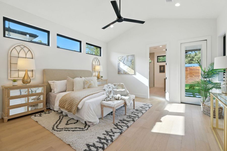 Bedroom featuring access to outside, light wood-type flooring, a ceiling fan, recessed lighting, and high vaulted ceiling Bedroom featuring access to outside, light wood-type flooring, a ceiling fan, recessed lighting, and high vaulted ceiling