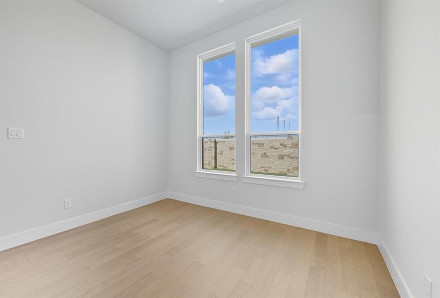 Empty room featuring light wood-style floors and baseboards Empty room featuring light wood-style floors and baseboards
