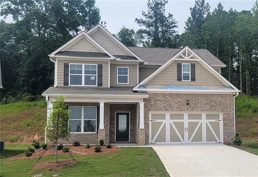 Front exterior of a new home in Clark Farms, Flowery Branch, GA, highlighting curb appeal (Image 1).