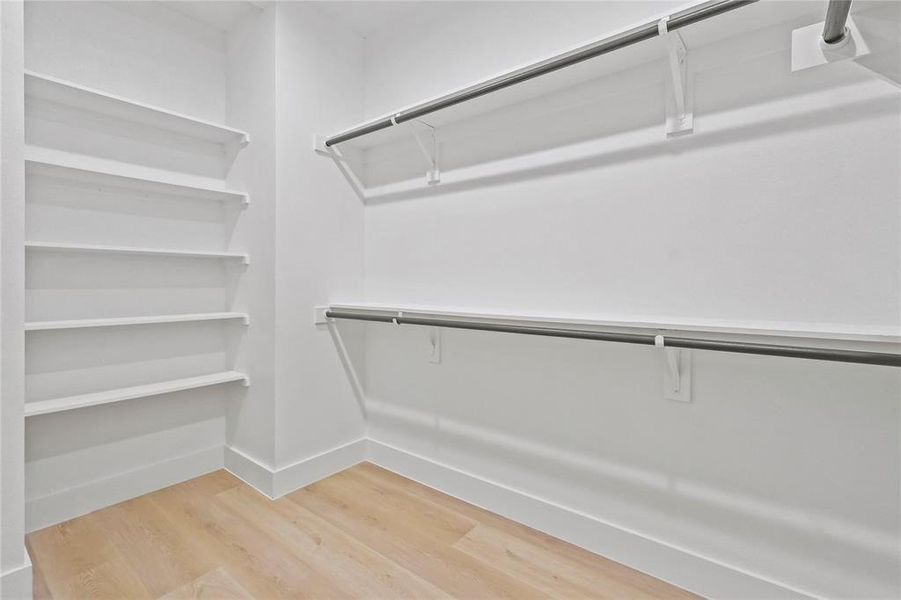 Walk in closet featuring light wood finished floors