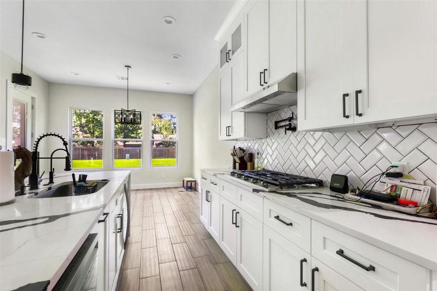 Kitchen Features Ample Counter Space and a Pot Filler over Range