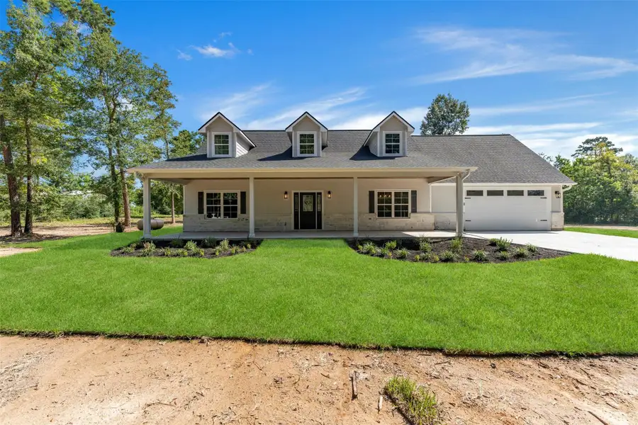 Front exterior of a new home in , New Waverly, TX, highlighting curb appeal (Image 23).