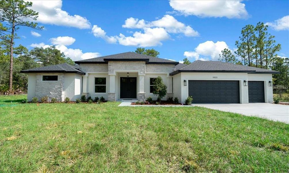 Front exterior of a new home in , Weeki Wachee, FL, highlighting curb appeal (Image 39). Front exterior of a new home in , Weeki Wachee, FL, highlighting curb appeal (Image 39).
