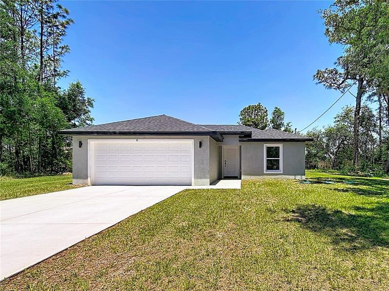 Front exterior of a new home in , Ocala, FL, highlighting curb appeal (Image 2). Front exterior of a new home in , Ocala, FL, highlighting curb appeal (Image 2).