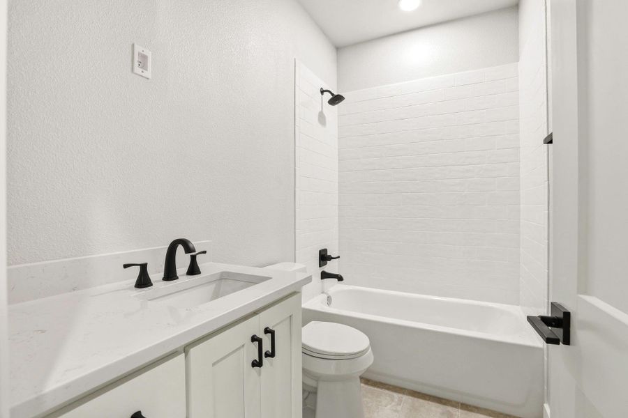 Modern fixtures enhance this pristine bathroom, featuring a clean tub and shower combination with subway tile surround. Modern fixtures enhance this pristine bathroom, featuring a clean tub and shower combination with subway tile surround.