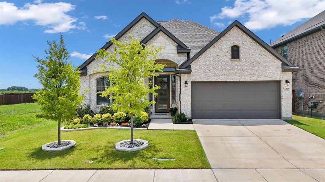 Modern brick and stone facade with a dark gray garage door Modern brick and stone facade with a dark gray garage door