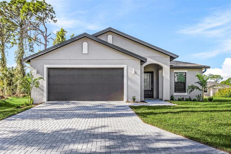 Front exterior of a new home in , North Port, FL, highlighting curb appeal (Image 1).