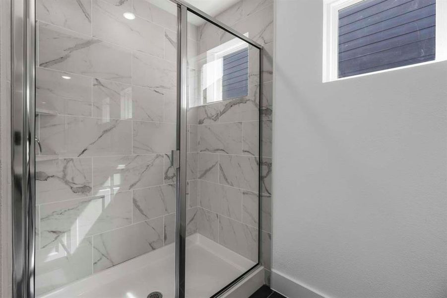 Full bath featuring a marble finish shower Full bath featuring a marble finish shower