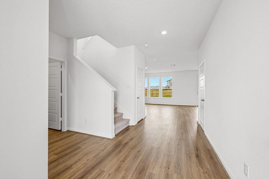 Upon entering, the stunning Layton Lake vinyl plank flooring in Wild Dunes captures the eye and makes the space bright and inviting.