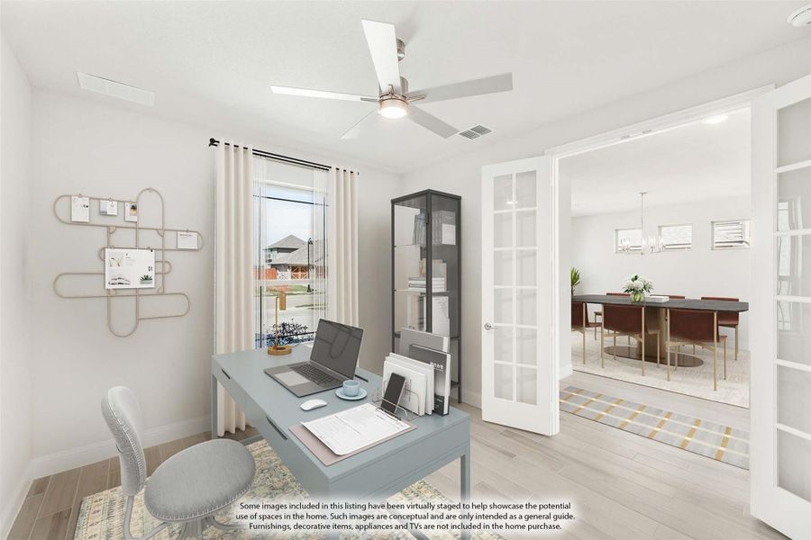 Home office with desk, ceiling fan, and French doors opening to dining room Home office with desk, ceiling fan, and French doors opening to dining room