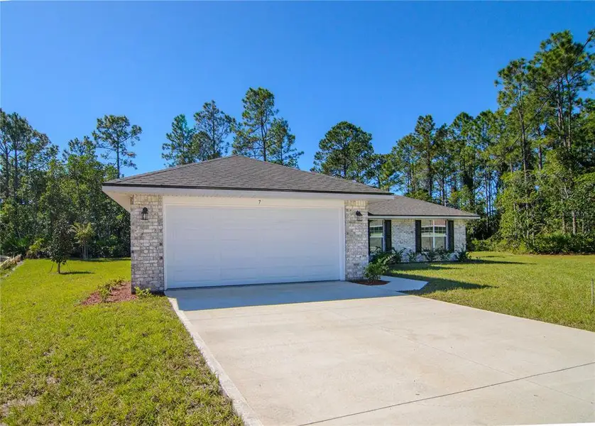 Front exterior of a new home in Palm Coast, Palm Coast, FL, highlighting curb appeal (Image 18). Front exterior of a new home in Palm Coast, Palm Coast, FL, highlighting curb appeal (Image 18).
