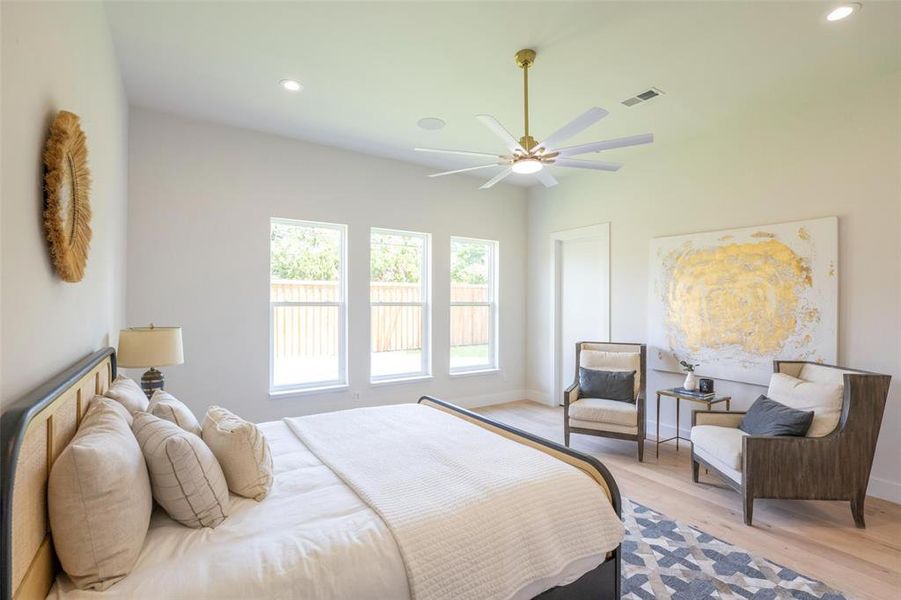 Bedroom featuring ceiling fan and light wood-type flooring Bedroom featuring ceiling fan and light wood-type flooring