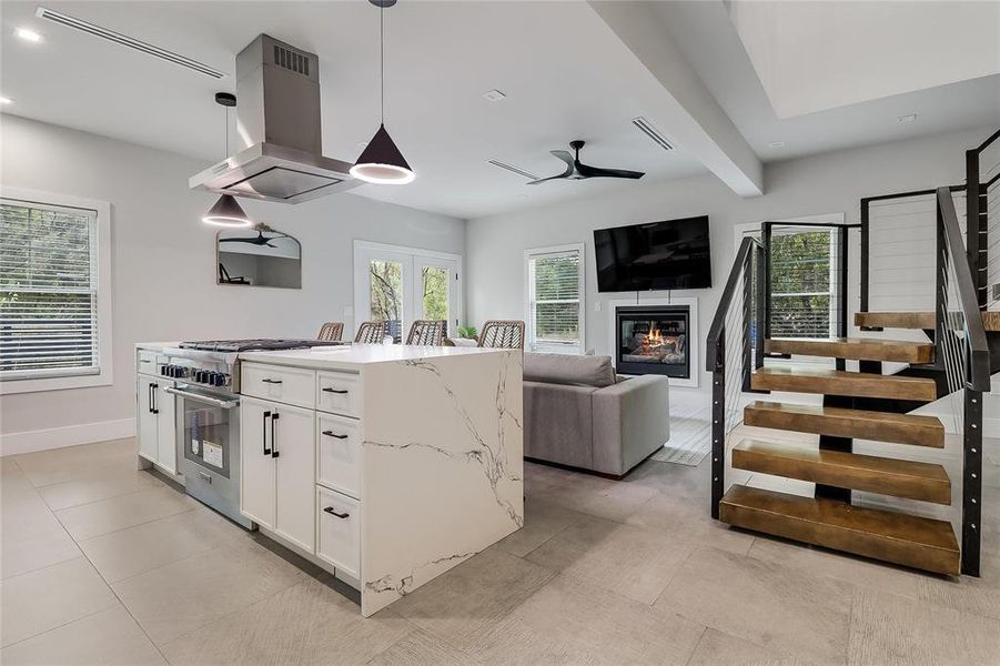 An open concept design seamlessly connects the kitchen to the inviting living area and contemporary staircase.