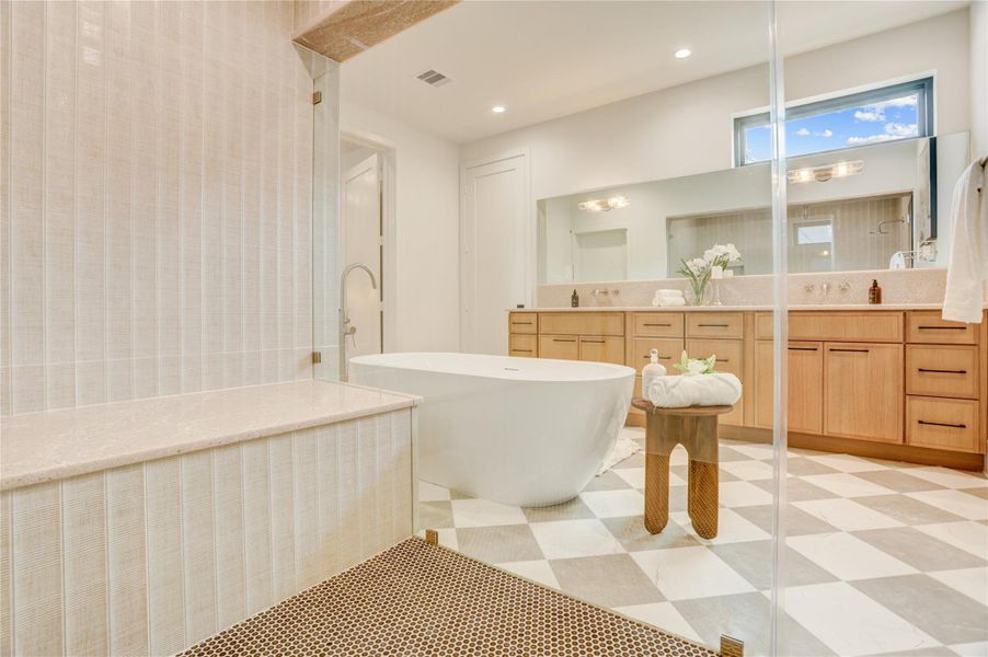 View from inside the walk-in shower with stone ledge seating.