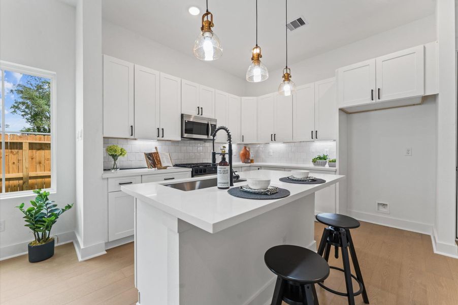 At the heart of this open-concept kitchen lies a stunning oversized island, offering generous prep space, sleek quartz countertops, and seating area. Whether you're hosting a dinner party or enjoying a casual breakfast, this island is the perfect gathering spot. Pendant lighting adds a touch of elegance, while built-in storage and a deep sink make it as functional as it is beautiful. At the heart of this open-concept kitchen lies a stunning oversized island, offering generous prep space, sleek quartz countertops, and seating area. Whether you're hosting a dinner party or enjoying a casual breakfast, this island is the perfect gathering spot. Pendant lighting adds a touch of elegance, while built-in storage and a deep sink make it as functional as it is beautiful.