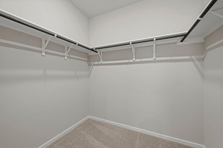 Walk-in closet in Primary Bedroom Walk-in closet in Primary Bedroom