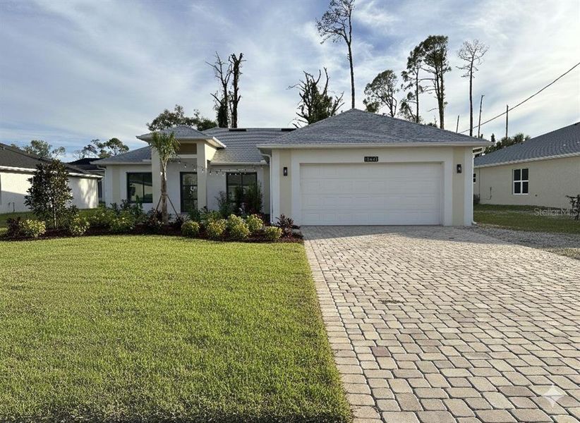 Front exterior of a new home in , Port Charlotte, FL, highlighting curb appeal (Image 1).