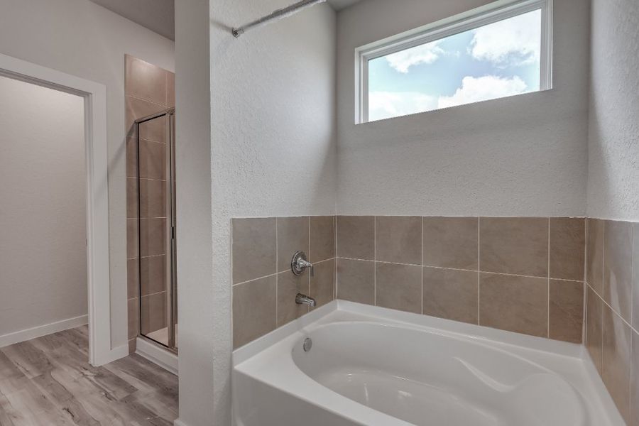 A bathroom with a bathtub and shower. A bathroom with a bathtub and shower.