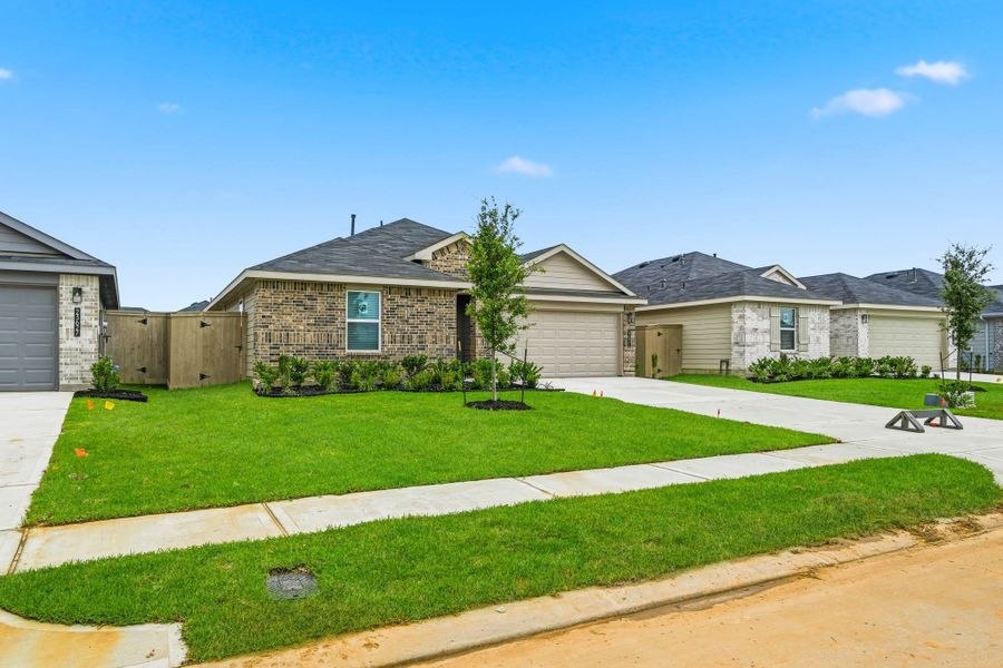 Front exterior of a new home in The Canopies, Splendora, TX, highlighting curb appeal (Image 13). Front exterior of a new home in The Canopies, Splendora, TX, highlighting curb appeal (Image 13).