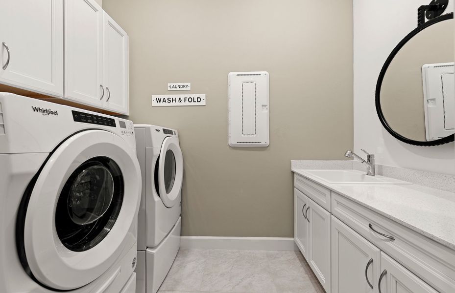 Finished utility room with cabinets for extra stor Finished utility room with cabinets for extra stor