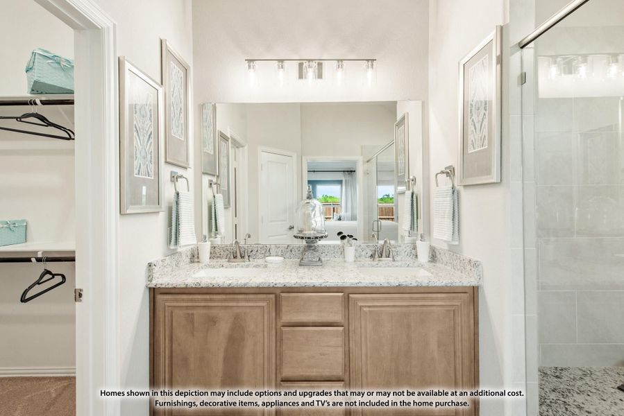 Bathroom with double sink vanity, wood cabinets, granite countertop, large mirror, and glass shower nearby. Bathroom with double sink vanity, wood cabinets, granite countertop, large mirror, and glass shower nearby.