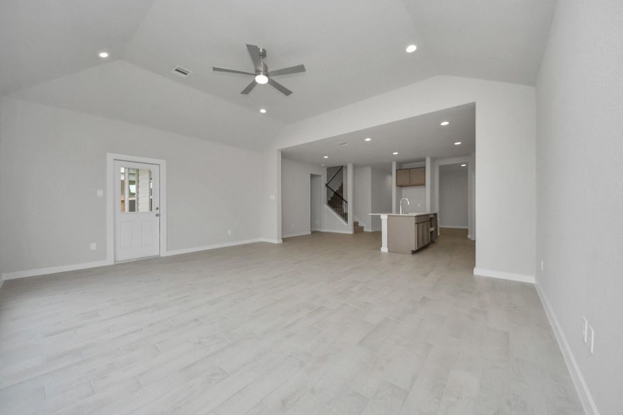 Welcome family and guests to your charming living room! With its high ceilings,recessed lighting, ceiling fan, custom paint, and beautiful flooring. Sample photo of completed home with similar floor plan. Actual colors and selections may vary. Welcome family and guests to your charming living room! With its high ceilings,recessed lighting, ceiling fan, custom paint, and beautiful flooring. Sample photo of completed home with similar floor plan. Actual colors and selections may vary.