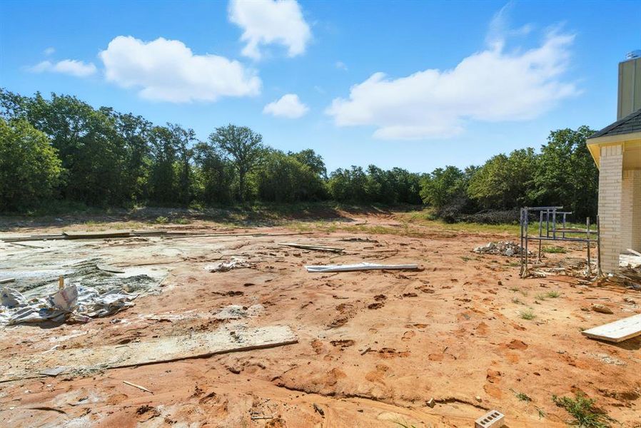 View of yard featuring view of wooded area View of yard featuring view of wooded area