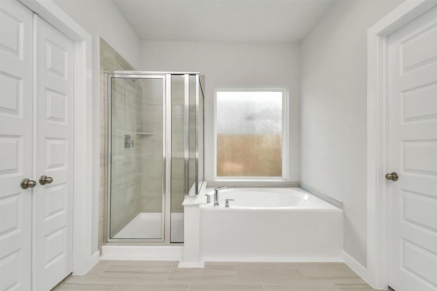 The primary en-suite has a soaking tub to give you that spa experience. The large privacy window allow lots of nature light in the space.