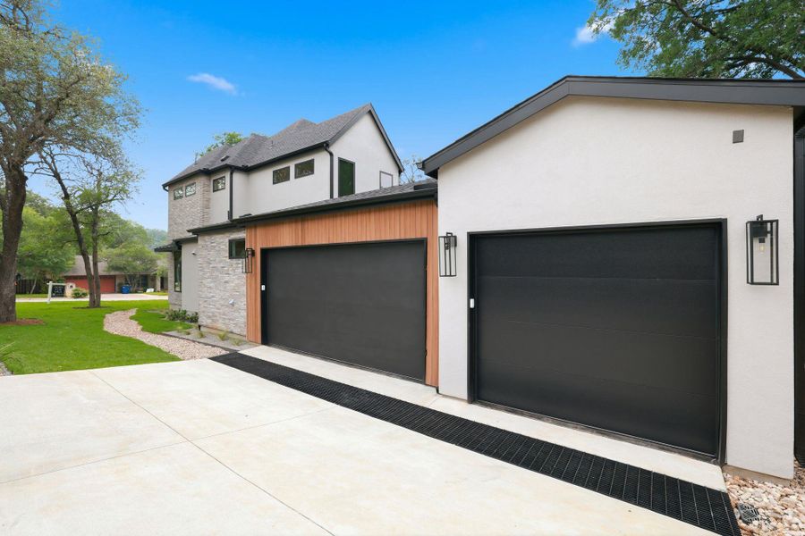 Contemporary exterior featuring stucco, stone, and wood-finish siding