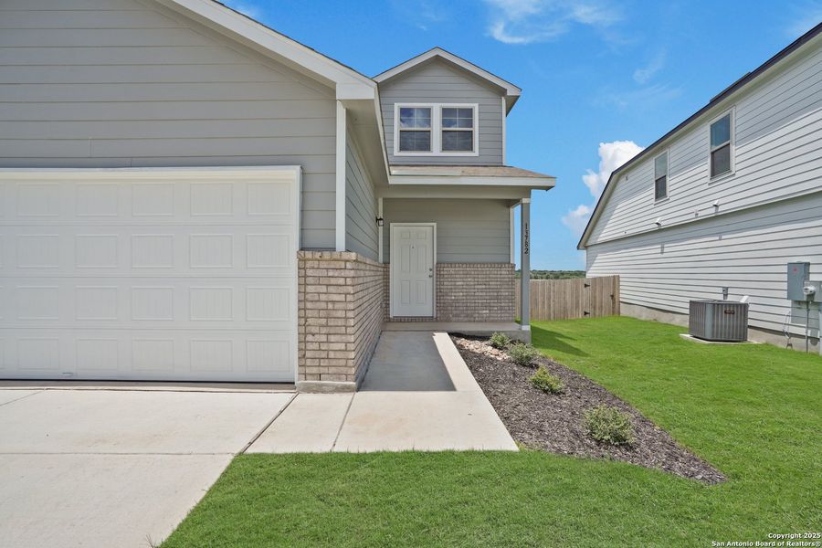 Front exterior of a new home in Cinco Lakes, San Antonio, TX, highlighting curb appeal (Image 23). Front exterior of a new home in Cinco Lakes, San Antonio, TX, highlighting curb appeal (Image 23).
