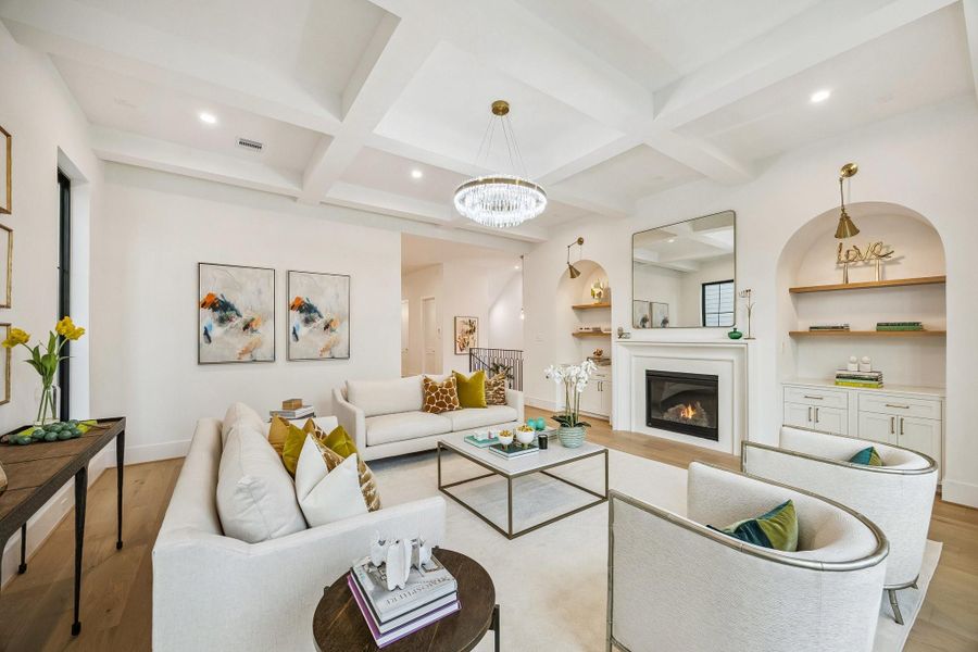 Another view of the Living Room Showcases the Shaker Style Inset Cabinets Doors, White Oak Floating Shelves with a Natural Stain, Two Swing Arm Sconces with Brass Gold Finish.  There is also a Conduit above the Fireplace for a TV.