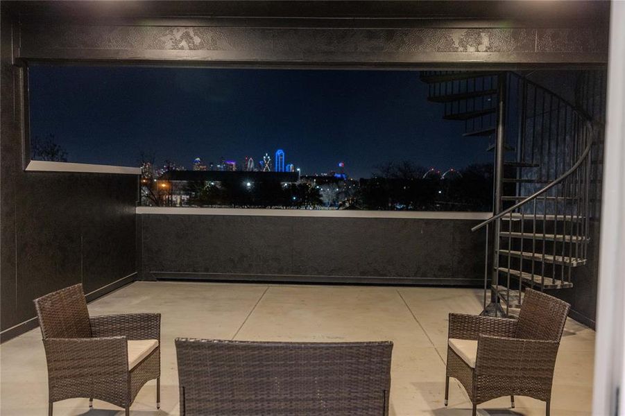 Spacious third-floor covered patio featuring a ceiling fan and sweeping panoramic city views, perfect for enjoying both daytime sunshine and nighttime city lights. Spacious third-floor covered patio featuring a ceiling fan and sweeping panoramic city views, perfect for enjoying both daytime sunshine and nighttime city lights.
