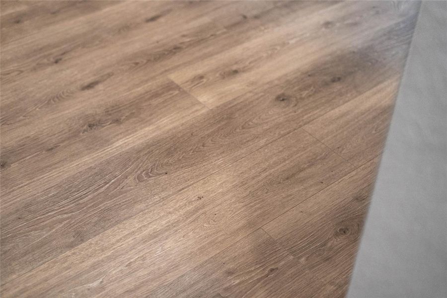 The photo highlights the Revwood laminate flooring in Sail Cloth which flows throughout the main living areas.