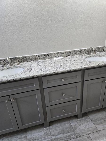 Bathroom featuring tile flooring and vanity