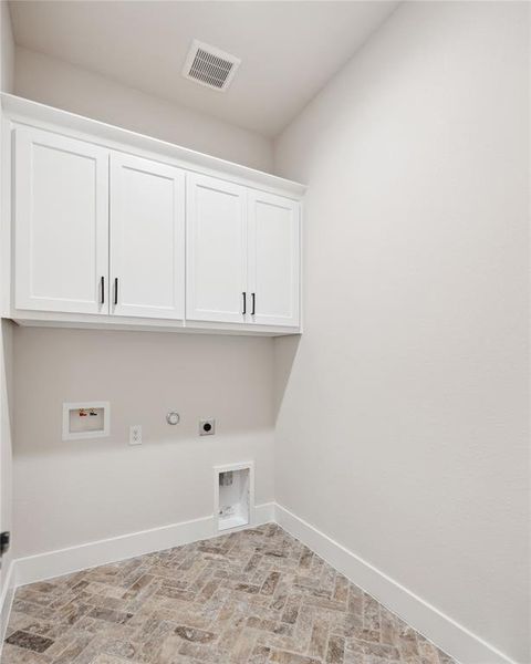 Washroom with electric dryer hookup, cabinets, washer hookup, and gas dryer hookup