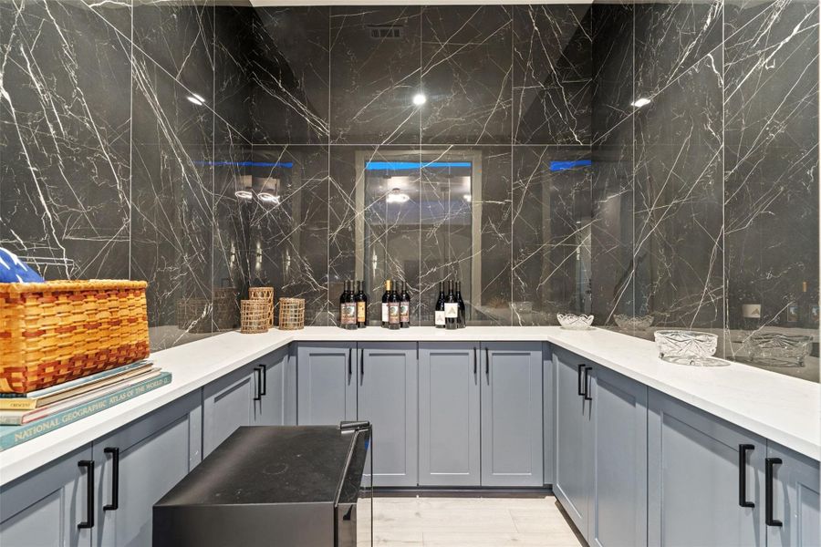 Designed for unforgettable entertaining, the lower level features a barrel-ceiling home theater, expansive game room, stylish bar, and temperature-controlled wine cellar.