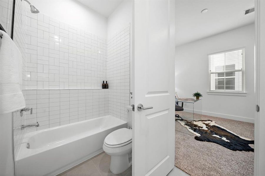 Full bathroom on the 1st floor nestled between two secondary bedrooms!