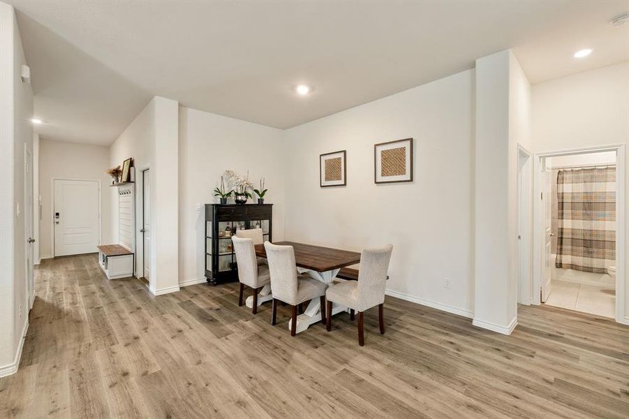 Dining space with light wood-style flooring and recessed lighting Dining space with light wood-style flooring and recessed lighting