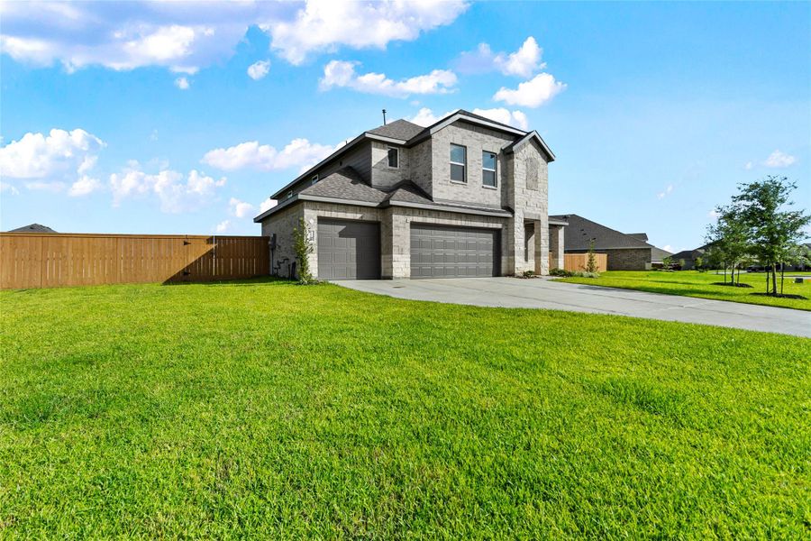 Front exterior of a new home in River Ranch Estates, Dayton, TX, highlighting curb appeal (Image 2). Front exterior of a new home in River Ranch Estates, Dayton, TX, highlighting curb appeal (Image 2).