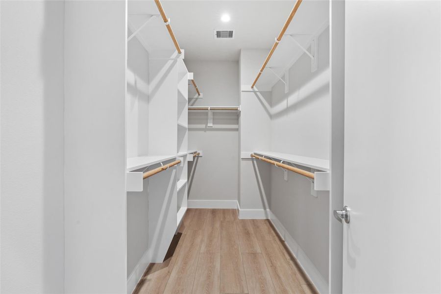 Spacious walk-in closet with built-in shelving & ample hanging space. Designed to keep your wardrobe organized & easily accessible. Spacious walk-in closet with built-in shelving & ample hanging space. Designed to keep your wardrobe organized & easily accessible.