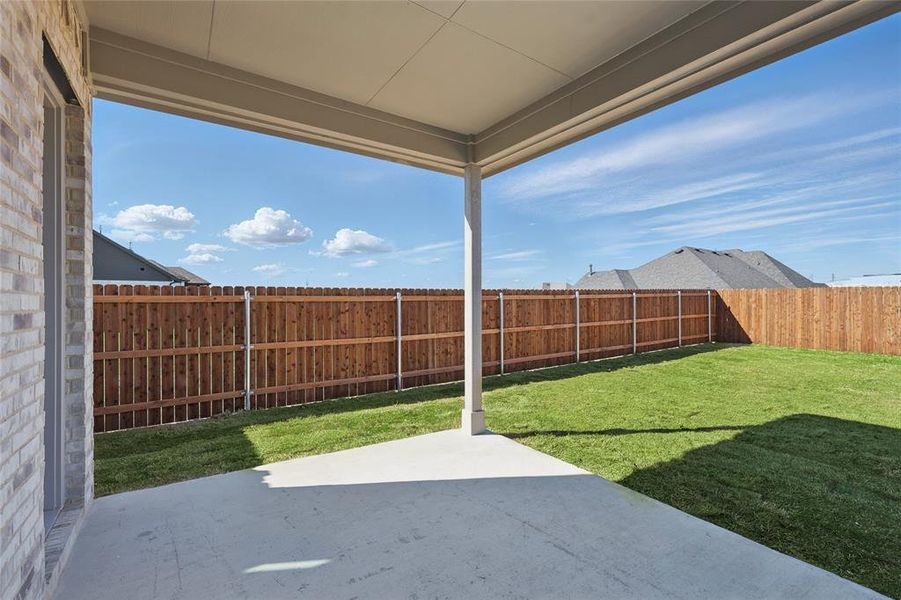 Fenced backyard featuring a patio area Fenced backyard featuring a patio area
