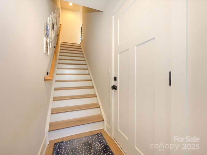 Wide staircase with wood tread stairs.  Easy access to the HUGE garage.