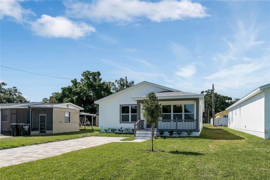 Front Of Home w/ Long Paver Driveway