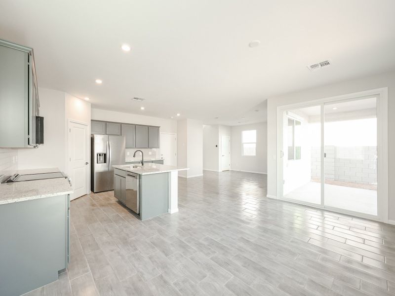 A large kitchen with a wood floor. A large kitchen with a wood floor.