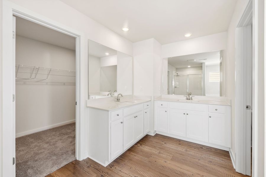 A bathroom with white cabinets. A bathroom with white cabinets.