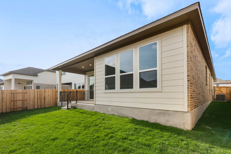 Exterior details and patio area of a home in Lariat, Liberty Hill (Image 26).